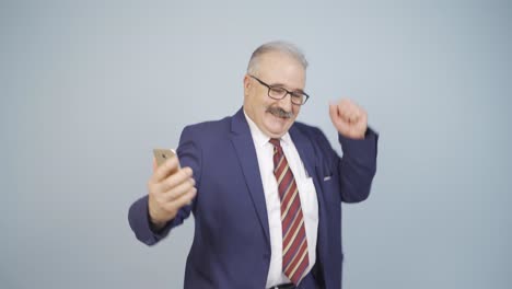 Businessman-dancing-with-phone-in-hand.